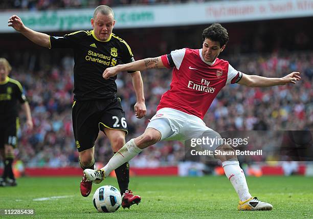 Jay Spearing of Liverpool tackles Cesc Fabregas of Arsenal and gives away a penalty kick during the Barclays Premier League match between Arsenal and...