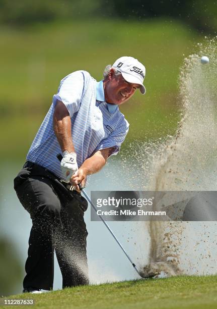 Russ Cochran hits out of a bunker on the 15th hole during the final round of the Outback Steakhouse Pro-Am at the TPC of Tampa on April 17, 2011 in...