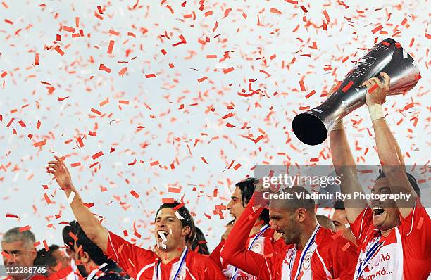 Albert Riera of Olympiacos races the winner's trophy after finishing first with Olympiacos in the regular season and claiming it's historicaly 38th...