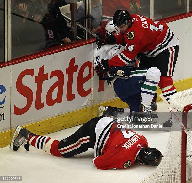 Chris Campoli of the Chicago Blackhawks hits Raffi Torres of the Vancouver Canucks after Torres knocked down Brent Seabrook with a hit behind the net...