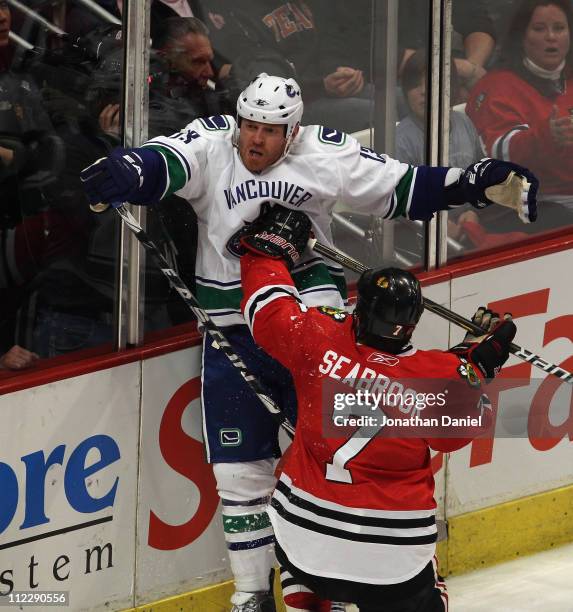 Brent Seabrook of the Chicago Blackhawks hits Raffi Torres of the Vancouver Canucks in the chest with his stick after Torres took him down in the 2nd...