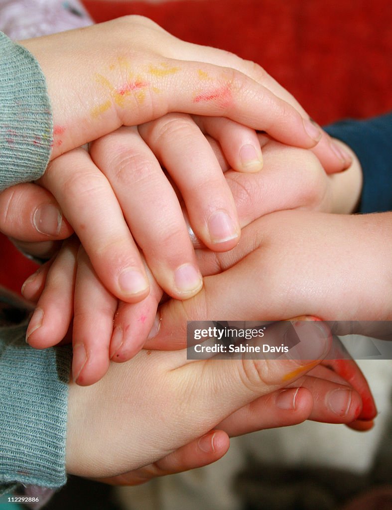 Children's hands stacked together