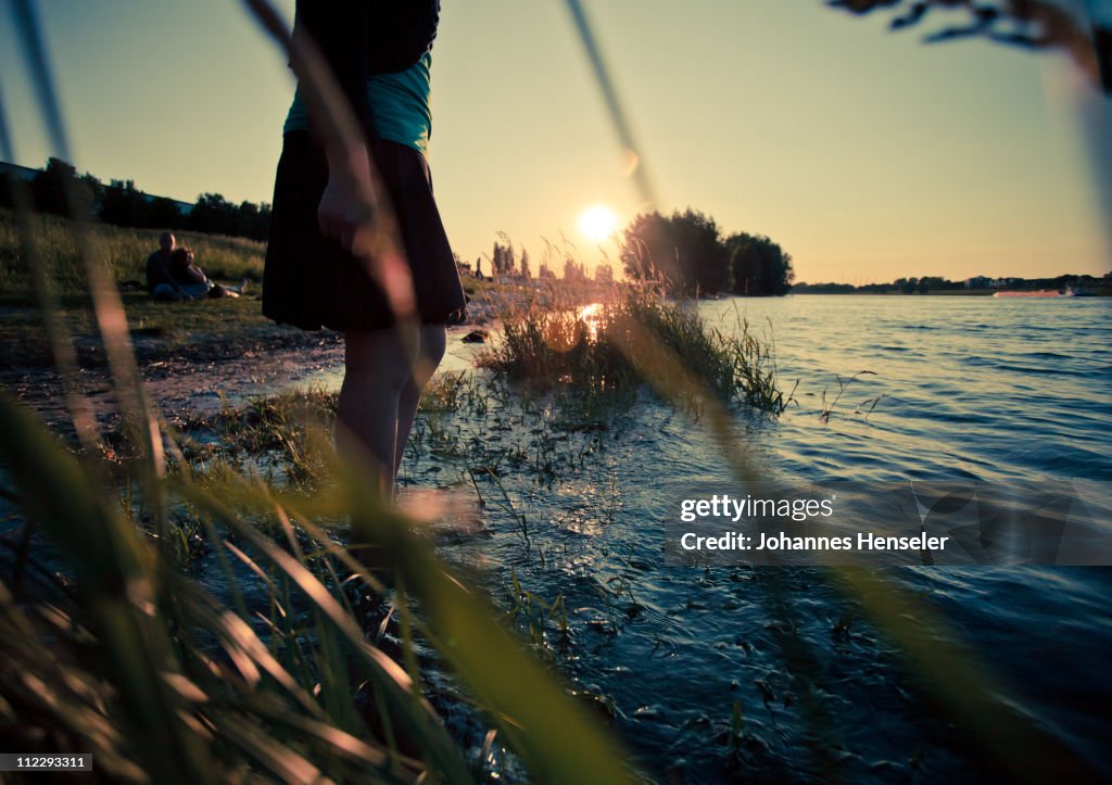 Young woman bathing her feet in the river