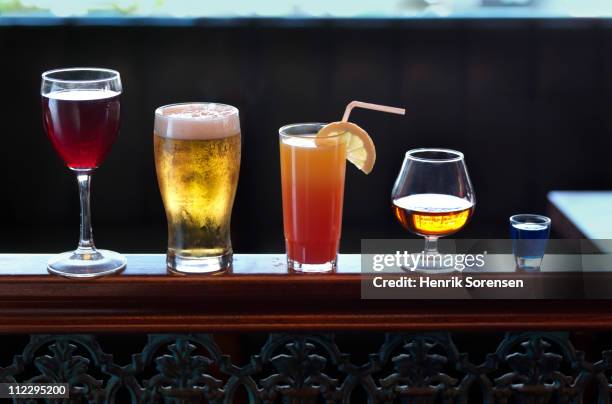 row of assorted drinks in a bar - beer stock pictures, royalty-free photos & images