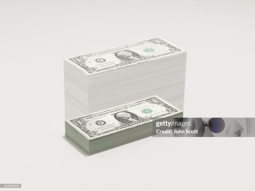 A growing pile of dollar bills