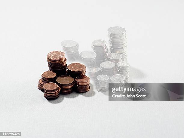 a growing pile of coins - pile of money stock pictures, royalty-free photos & images