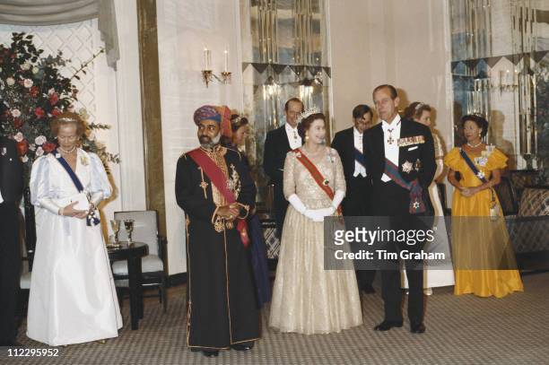 Duchess of Kent, Sultan Qaboos, Queen Elizabeth II, Prince Philip and Princess Margaret attending a banquet at Claridges, London, England, Great...