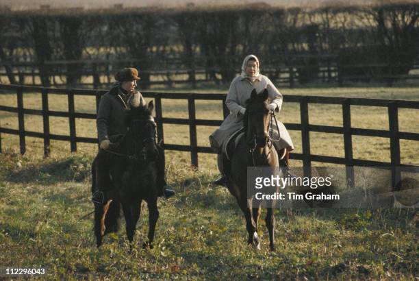 Princess Anne and Queen Elizabeth II horse riding on the Sandringham estate in Sandringham, Norfolk, England, Great Britain, circa 1979. Neither is...