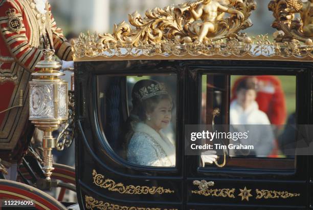 Queen Elizabeth II riding the State Coach as it leaves Buckingham Palace for the House of Lords and the State Opening of Parliament, in London,...