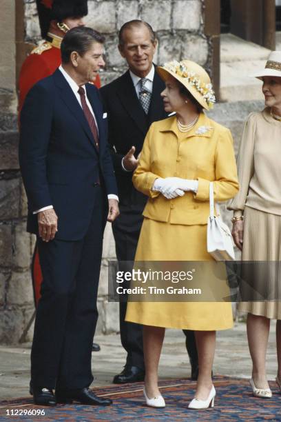 President Ronald Reagan with his wife, Nancy Reagan , Queen Elizabeth II and Prince Philip, during the ceremony in the Quadrangle at Windsor Castle...