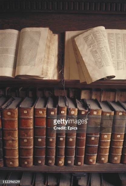 Manuscripts and antique books are kept chained on lecterns and bookshelves in Trinity college library, Cambridge University, Cambridgeshire, circa...
