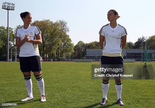 Dzsenifer Marozsan looks at Inka Grings poses during the photo call and team presentation of Germany for the FIFA Women's World Cup 2011 at...