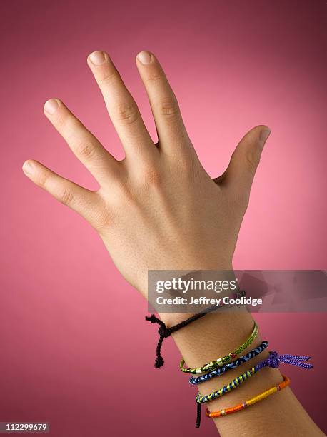 friendship bracelets on wrist - bracelet fotografías e imágenes de stock