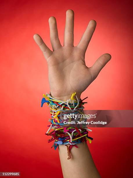 rubber bracelet bands on wrist - rubber bracelet stock pictures, royalty-free photos & images