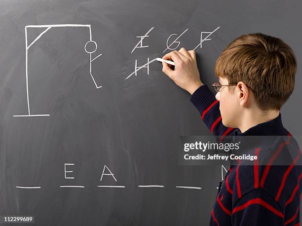 boy playing hangman - playing board games stock pictures, royalty-free photos & images