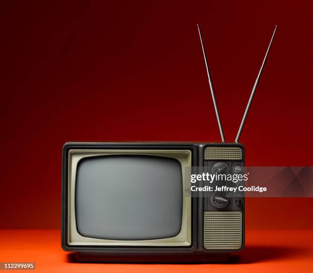 analog tv and rabbit ears - objects on coloured background stock pictures, royalty-free photos & images