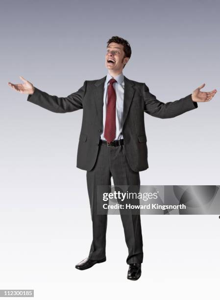 male executive pulling faces - man with arms raised stock pictures, royalty-free photos & images