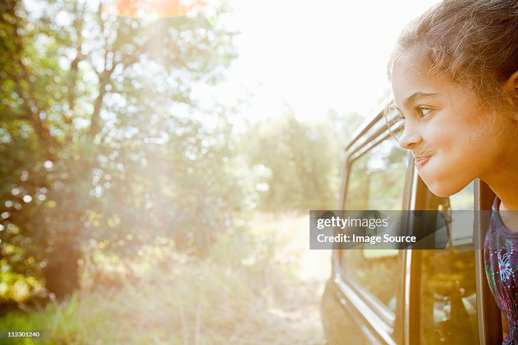 Girl making faces from a car