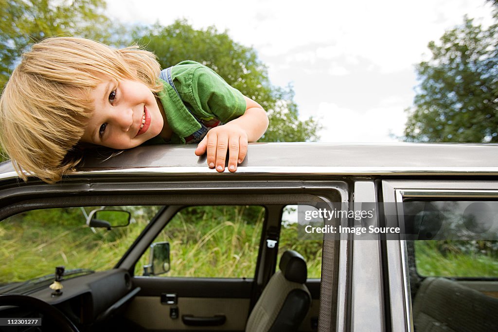 Boy on roof of car