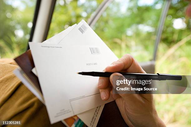 person writing postcards - postcards stock pictures, royalty-free photos & images