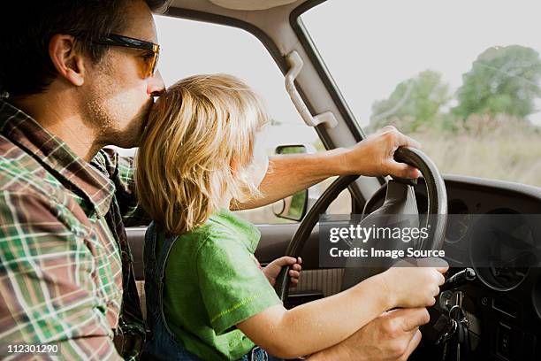 father and son at wheel of a car - car young driver stockfoto's en -beelden