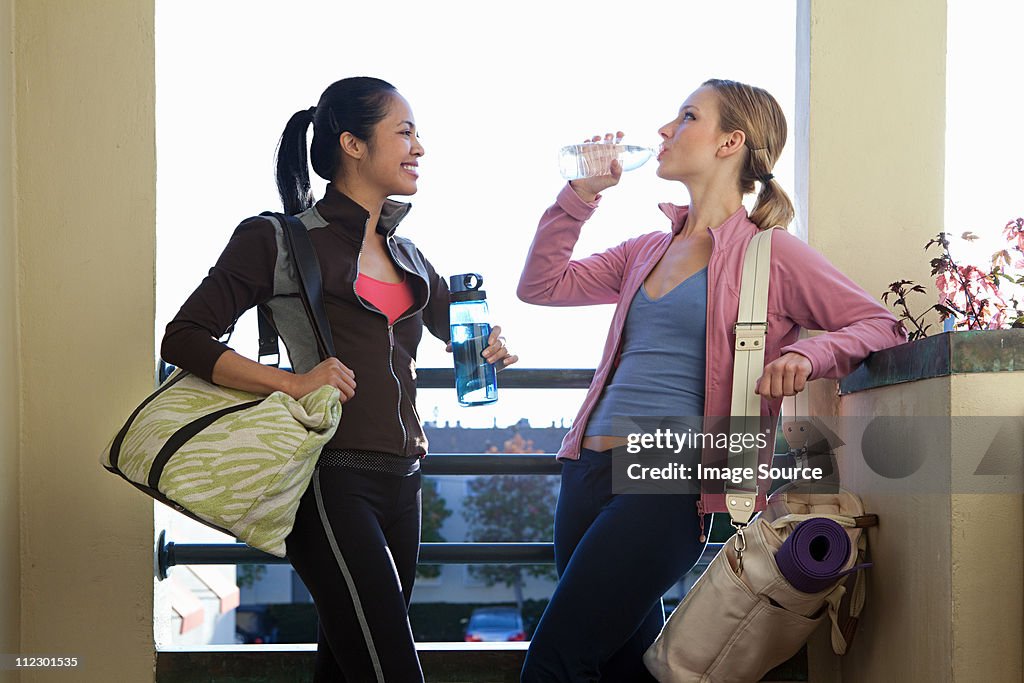 Two women with gym bags