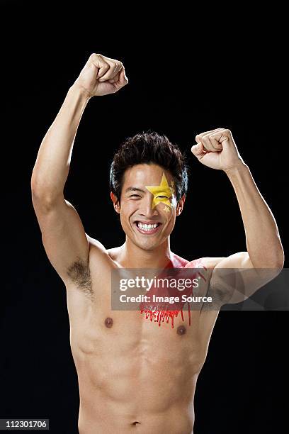 man with chinese flag painted on face and shoulder cheering - semi dress stock pictures, royalty-free photos & images