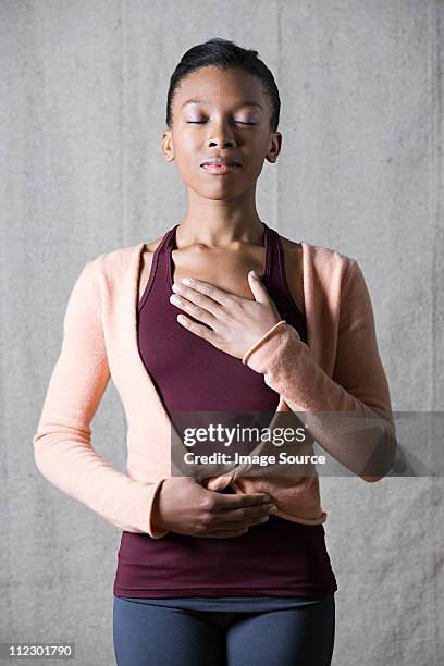 women breathing deeply, touching chest and abdomen - breathing chest foto e immagini stock