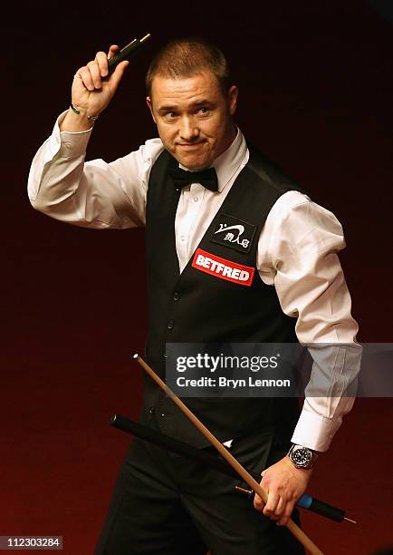 Stephen Hendry of Scotland waves after beating Joe Perry of England in his round one game on day three of the Betfred.com World Snooker Championship...