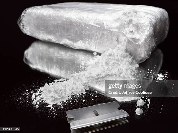 drug brick torn open - narcotic stock pictures, royalty-free photos & images