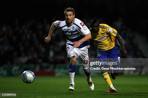 Kaspars Gorkss of QPR and Theo Robinson of Derby chase the ball during the npower Championship match between Queens Park Rangers and Derby County at...