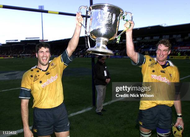 John Eales and Justin Harrison of Australia with the Bledisloe Cup after the Tri Nations match between Australia and New Zealand, Australia defeated...