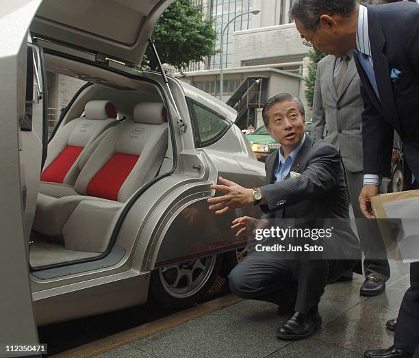 Kenji Kosaka of Minister of Education, Culture, Sports, Science and Technology pauses with Eliica created by Hiroshi Shimizu and the Keio University...