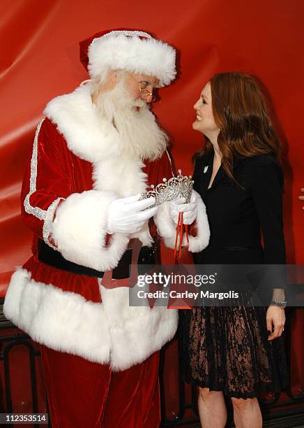 Santa Claus and Julianne Moore during Julianne Moore Unveils Cartier Tiaras at the 25th Anniversary of the Holiday Bow Celebration at The Cartier...