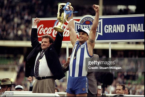 Wayne Carey and Dennis Pagan celebrate after North Melbourne won the Grand Final against the Sydney Swans in Melbourne, Australia.