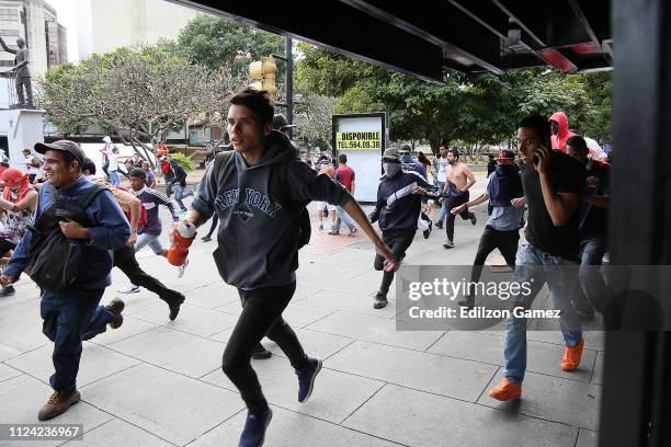 Demonstrators protest against the government of Nicolás Maduro before Venezuelan opposition leader and head of the National Assembly Juan Guaido...