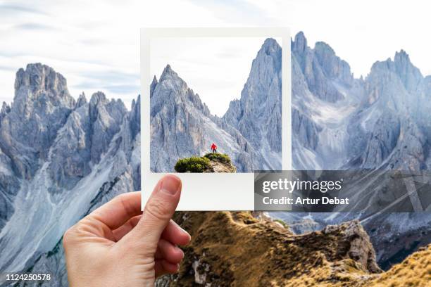 framing the italian alps dolomites with polaroid picture from personal perspective. - climber hands bildbanksfoton och bilder