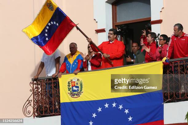 President of Venezuela Nicolás Maduro waves a national flag as he is escorted by Hector Rodriguez, Governor of Miranda; Diosdado Cabello, President...