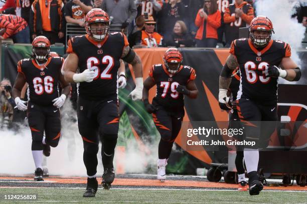 Alex Redmond and teammate Christian Westerman of the Cincinnati Bengals take the field for their game against the Denver Broncos at Paul Brown...