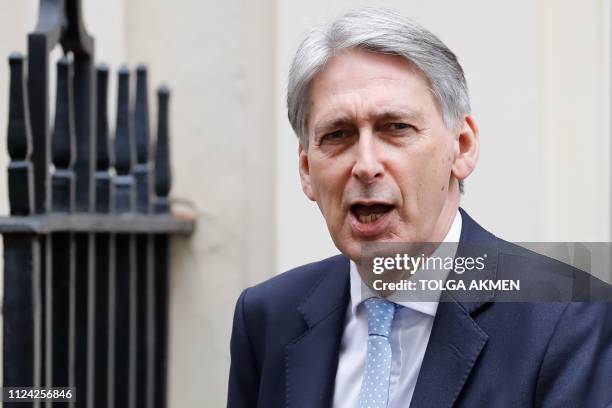 Britain's Chancellor of the Exchequer Philip Hammond leaves 11 Downing Street in London on February 12, 2019 ahead of a statement by the prime...