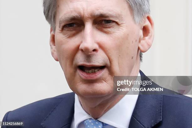 Britain's Chancellor of the Exchequer Philip Hammond leaves 11 Downing Street in London on February 12, 2019 ahead of a statement by the prime...
