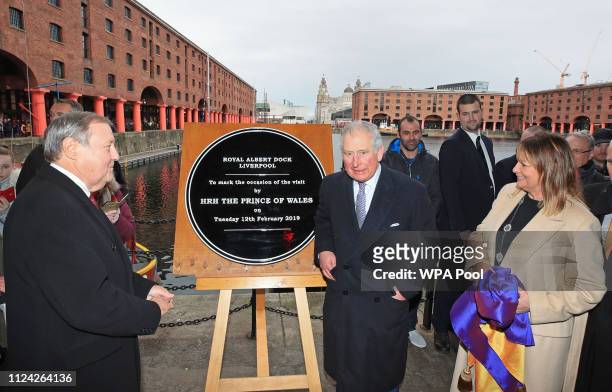Prince Charles, Prince of Wales unveils a plaque during a visit to Royal Albert Dock on February 12, 2019 in Liverpool, England. The Dock, which was...