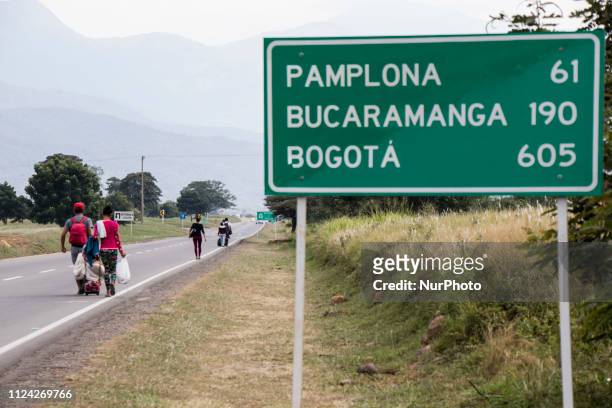 Venezuelan migrants rest as they walk on the road from Cucuta to Pamplona, in Norte de Santander Department, Colombia, on February 11, 2019....