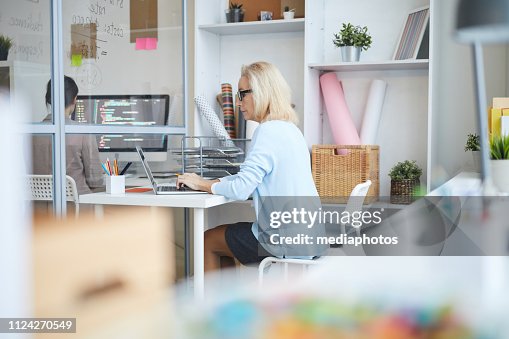 Old Programmer Lady Serious Thoughtful Mature Lady Programmer With Blond Hair Sitting At ...