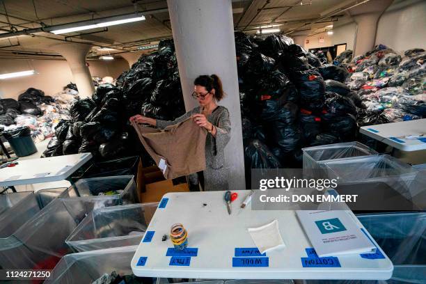 Fabscrap volunteer sorts fabric on February 1, 2019 at the company's warehouse in New York. - The fashion industry generates tons of textile waste,...