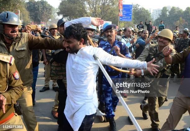 Police officials beat a supporters of Samajwadi party during a lathi charge , after a protest near Allahabad University , in Allahabad on February...
