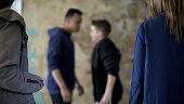 Teenage boys fighting, bullying and self-defense, violence, blurred background