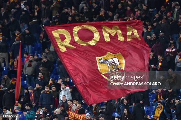Roma fans wave a huge flag as they cheer prior to the UEFA Champions League round of 16, first leg football match AS Roma vs FC Porto on February 12,...