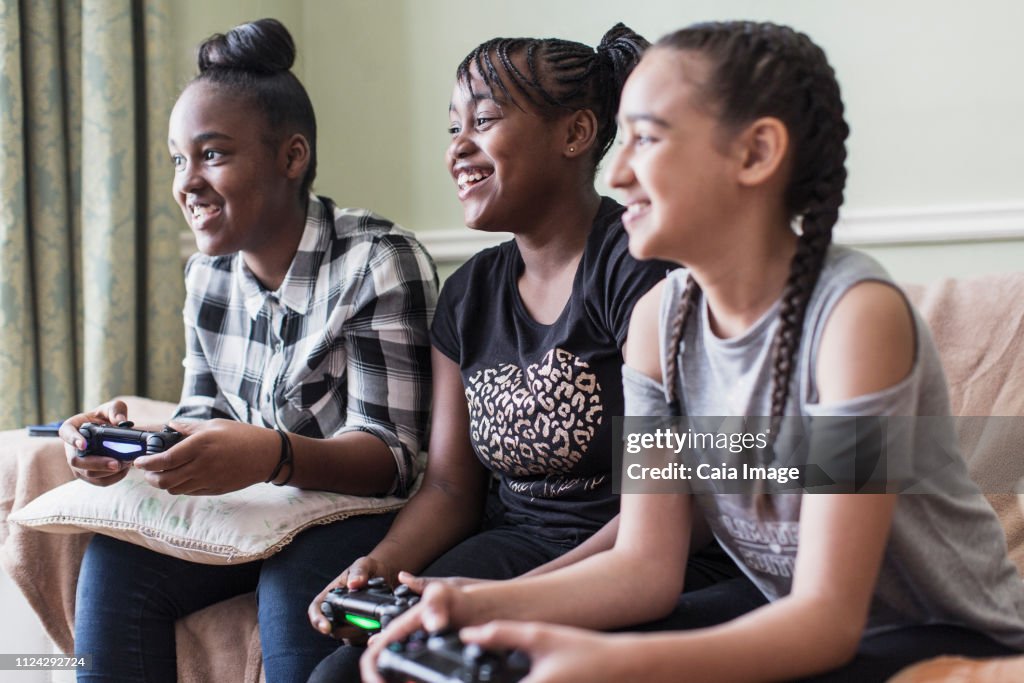 Tween Girl Friends Playing Video Game In Living Room High-Res Stock ...