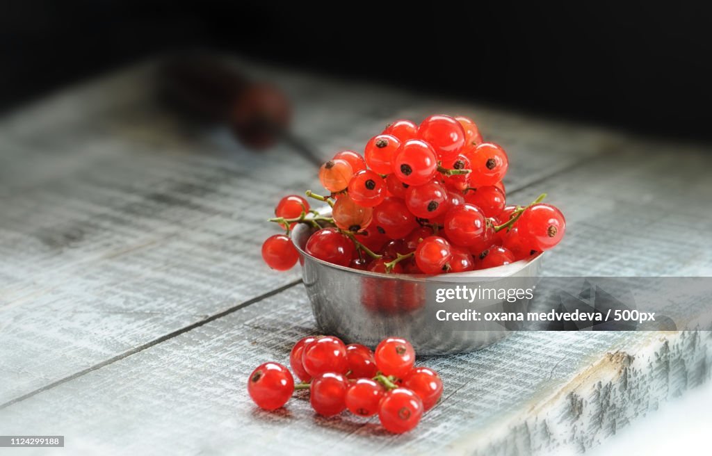 Berries Ripe Red Currants Lie On A Wooden Board In A Metal Spoon In The Beam Of Light.